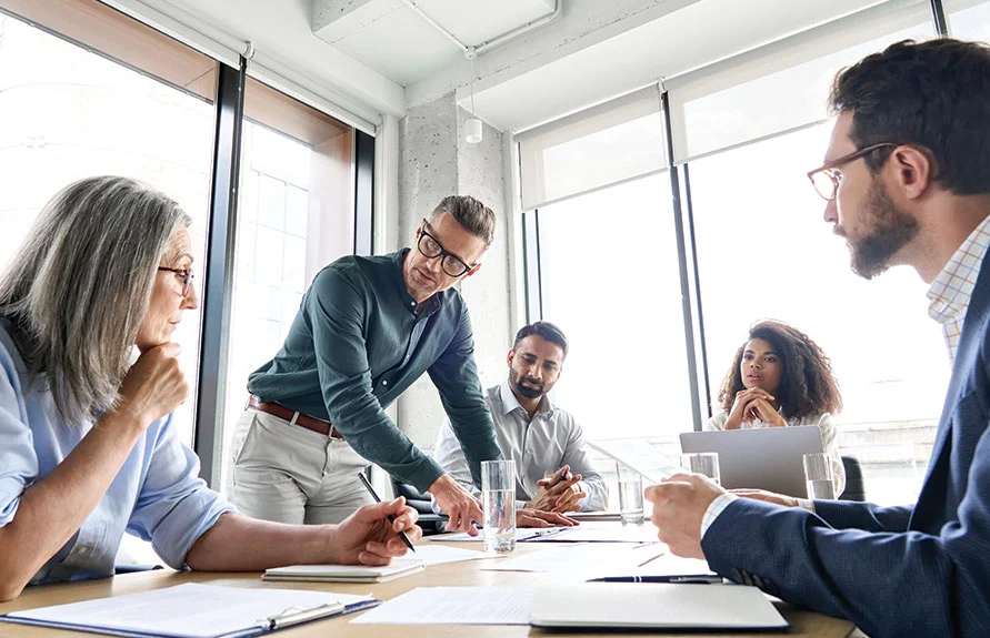 Attorney meeting with business clients around a conference table