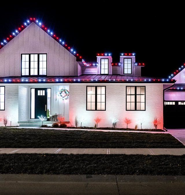 Evening view of a Providence, Huntsville home with permanent roofline lighting in warm white, the color-matched track invisible against the fascia
