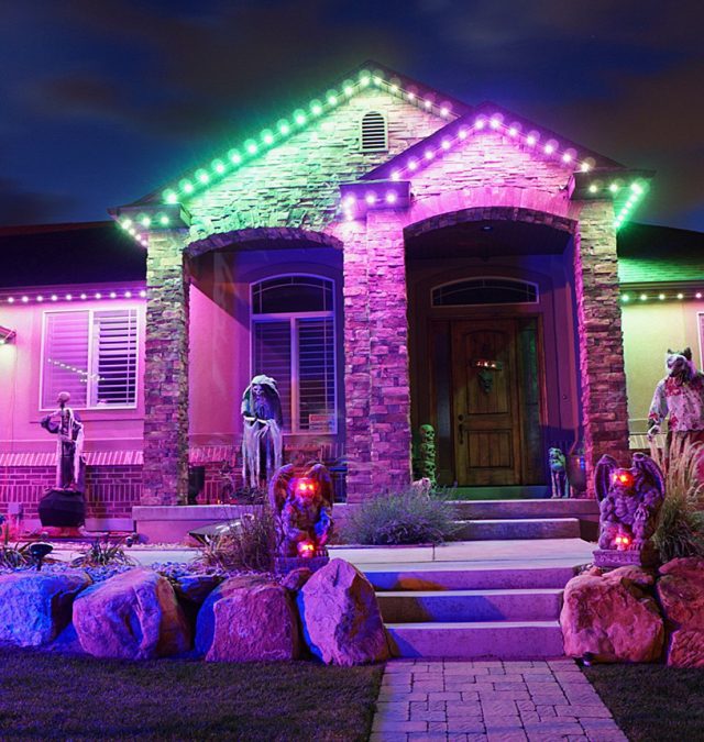 Warm white C9 roofline lighting on a two-story brick home in Farragut, Tennessee, installed by New Age Lights