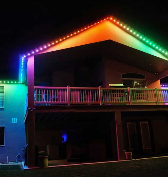 Warm white JellyFish permanent lighting along the straight fascia of a two-story brick and vinyl home in Mason, Ohio at dusk, installed by New Age Lights