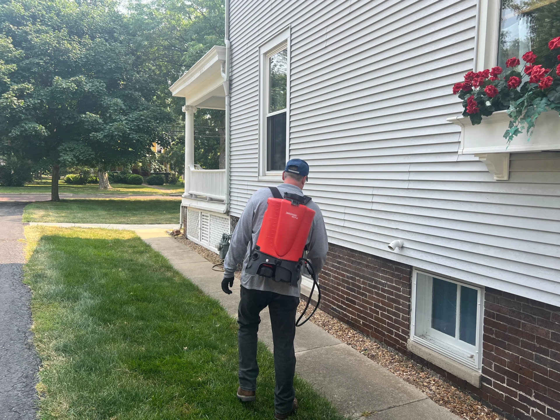 Technician applying a mosquito, flea and tick yard treatment