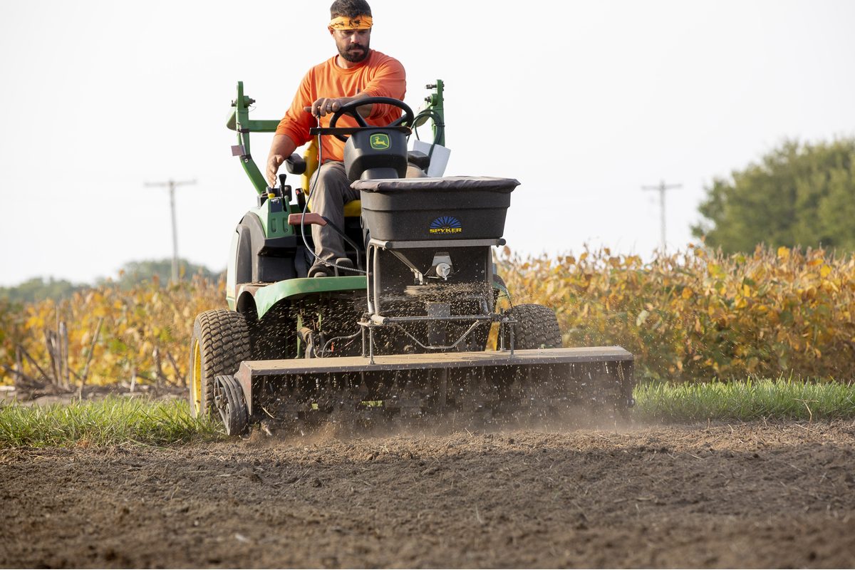 A Taylor's Way rig laying down grass seed with a slit seeder over prepared soil