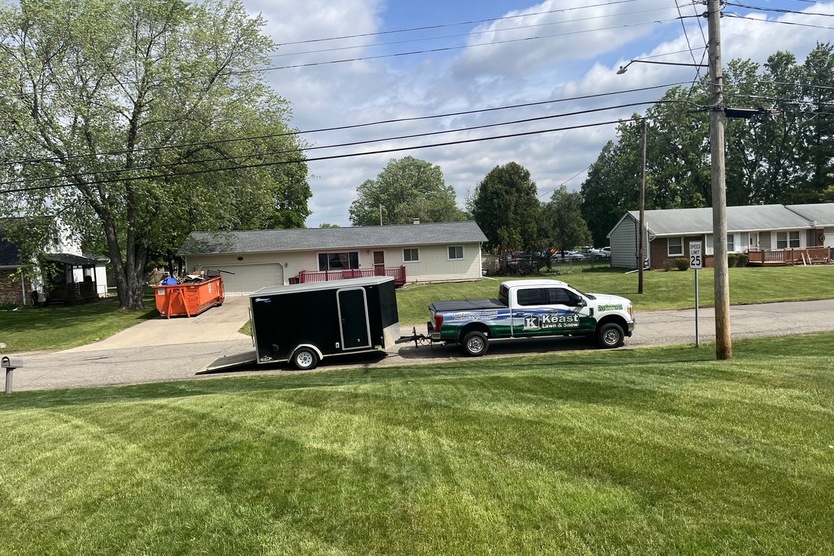 A Keast Lawn and Snow truck and trailer at a lush Michigan lawn for a late fall winterizer feeding