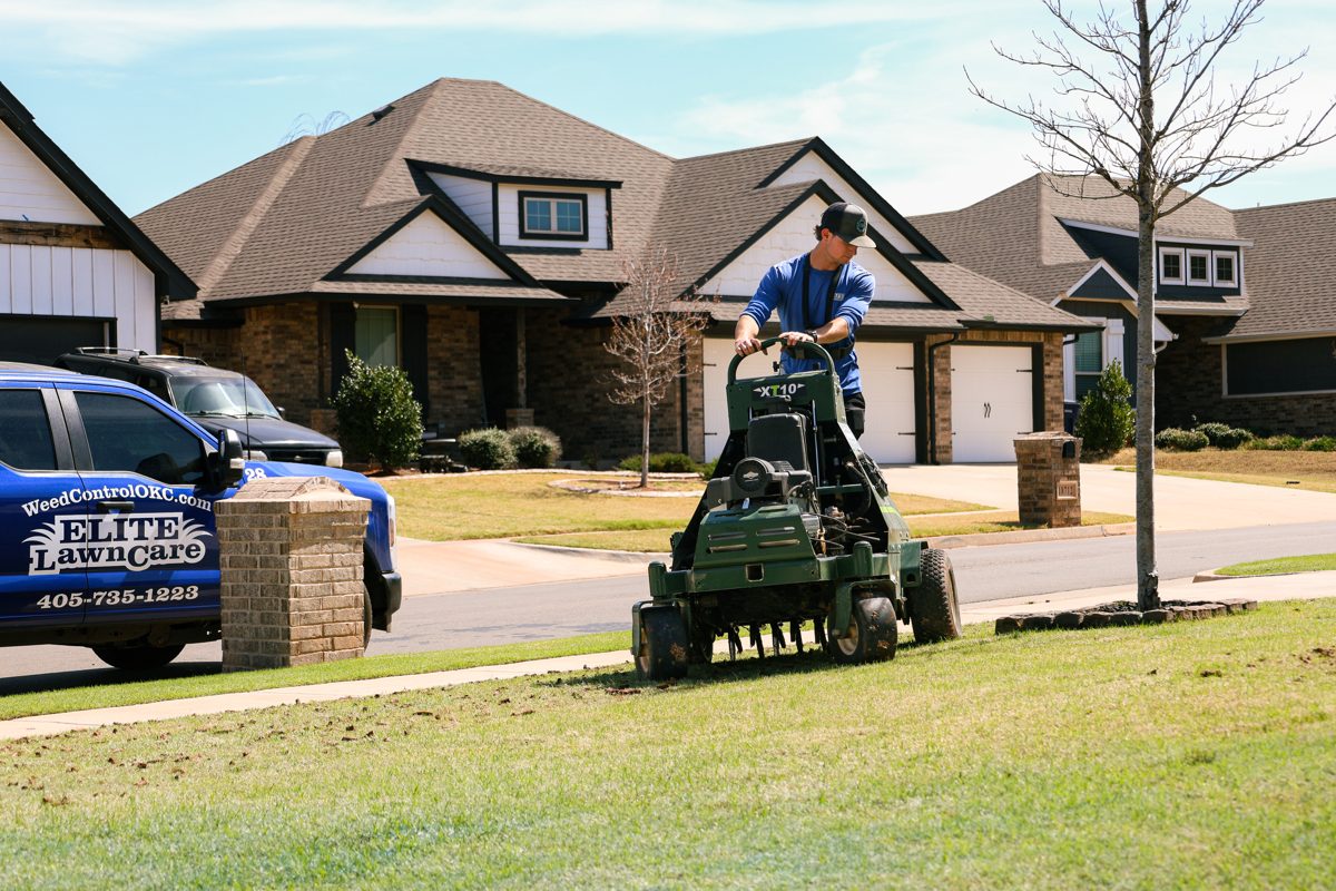 Elite Lawn Care aerator machine working a lawn ahead of fall overseeding