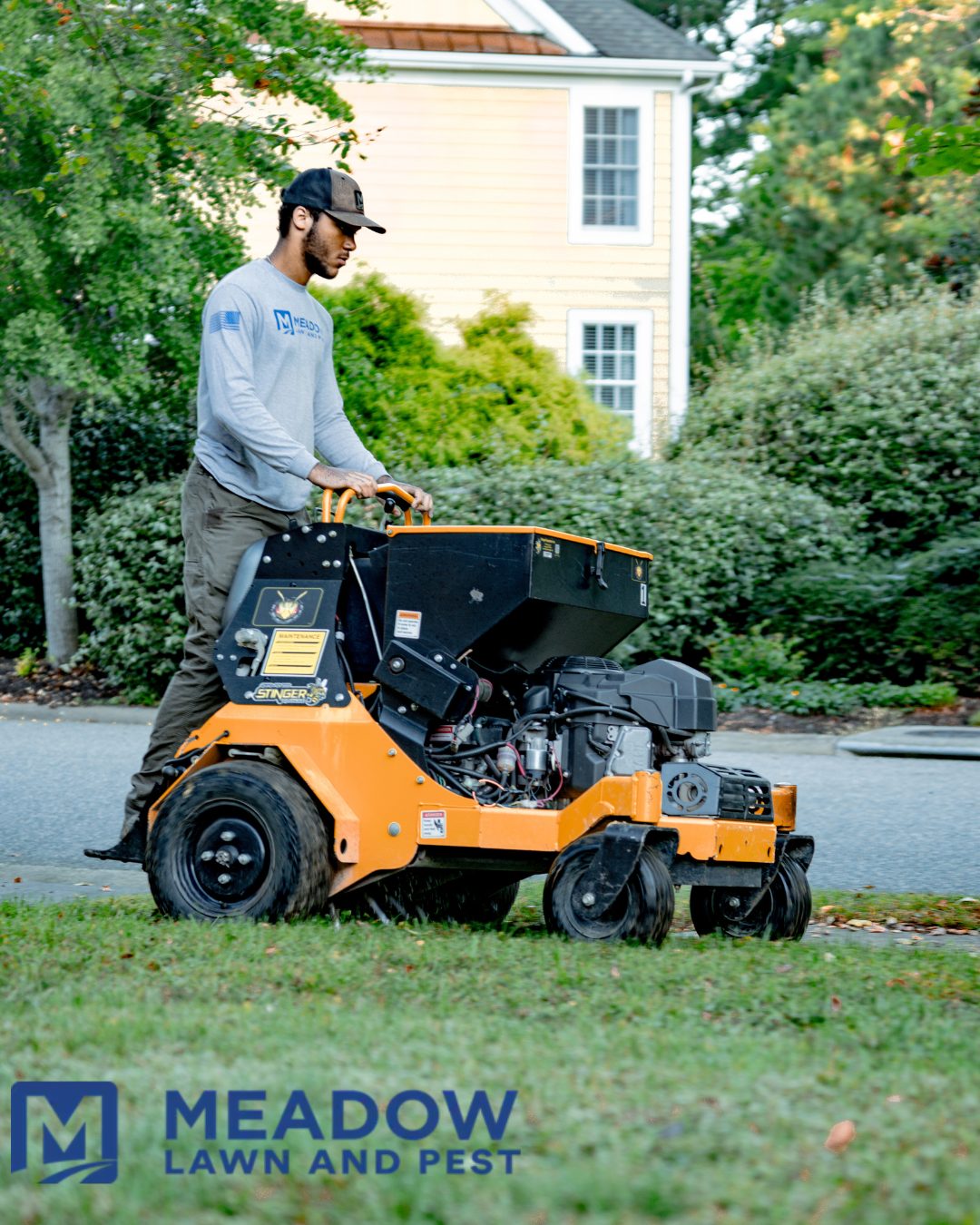 Meadow Lawn & Pest stand-on aerator working a coastal Virginia lawn in fall