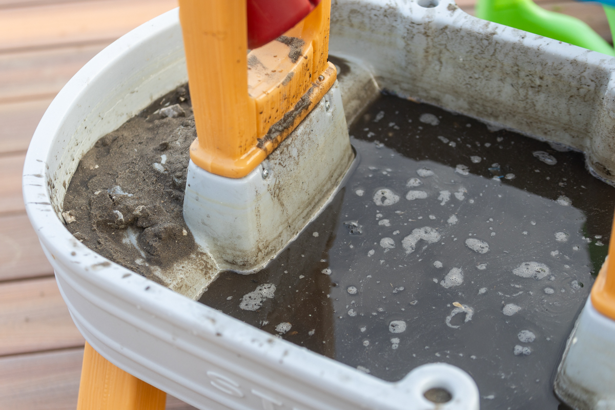 Dirty standing water collected in a child's outdoor water table